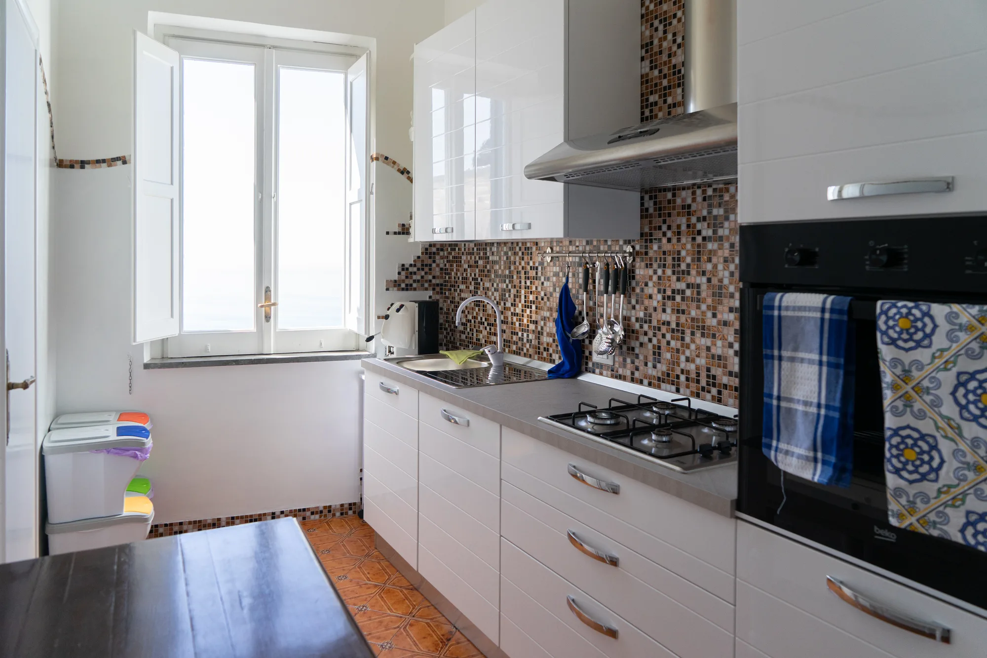 Modern kitchen with window light and patterned backsplash - interior photography on the Amalfi Coast by Cinereo