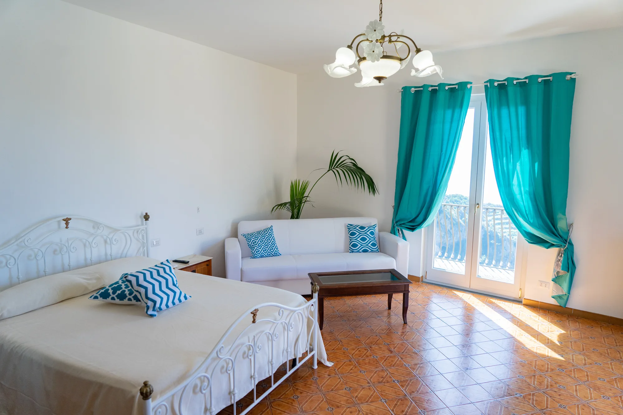 Bedroom with turquoise curtains and clean guest styling - interior photography on the Amalfi Coast by Cinereo