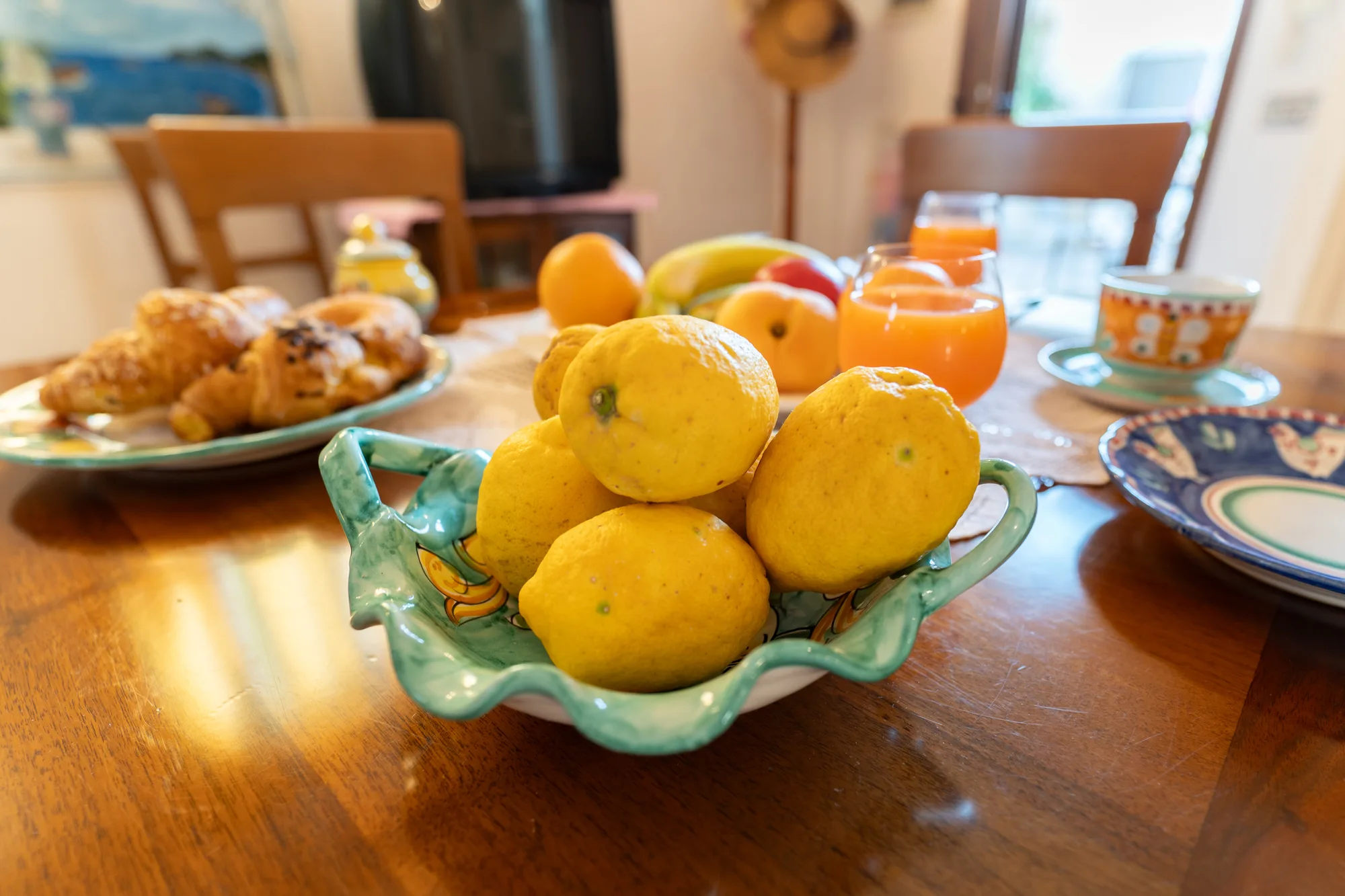 Breakfast table detail with Amalfi lemons and warm morning color - interior photography on the Amalfi Coast by Cinereo