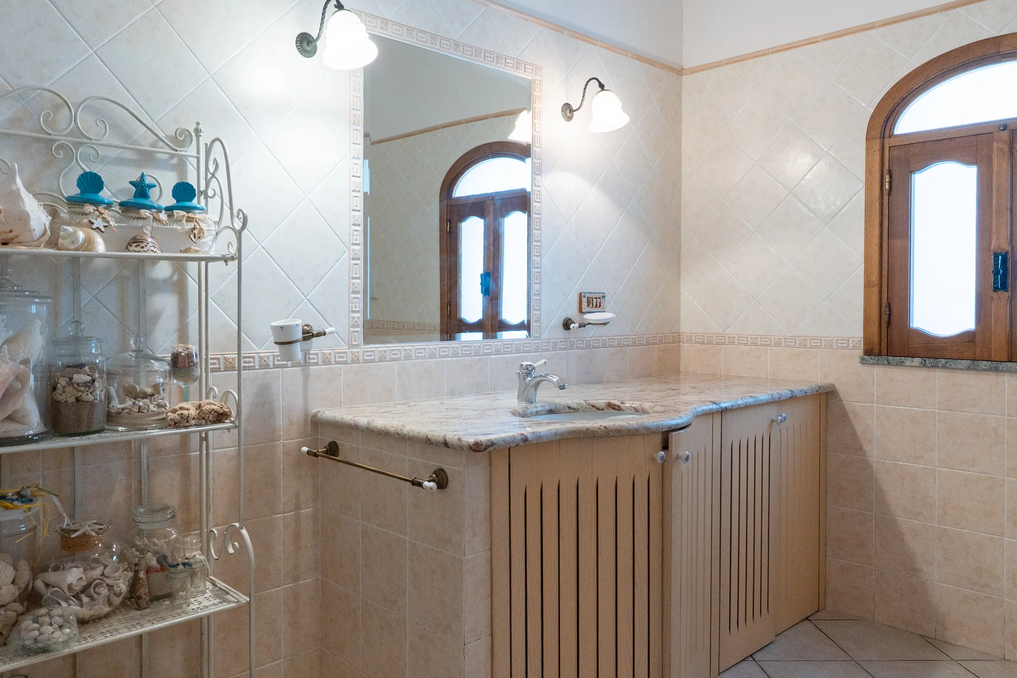 Bathroom vanity detail with warm wood, ceramics and clear mirror light - interior photography on the Amalfi Coast by Cinereo