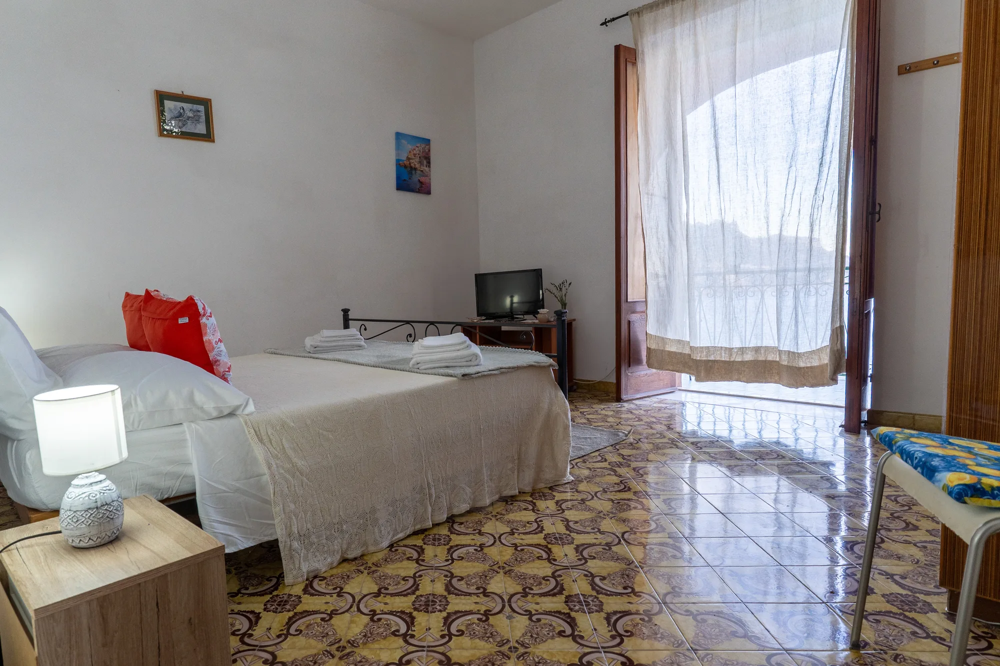 Wide bedroom view with balcony doors and sea-facing light - interior photography on the Amalfi Coast by Cinereo