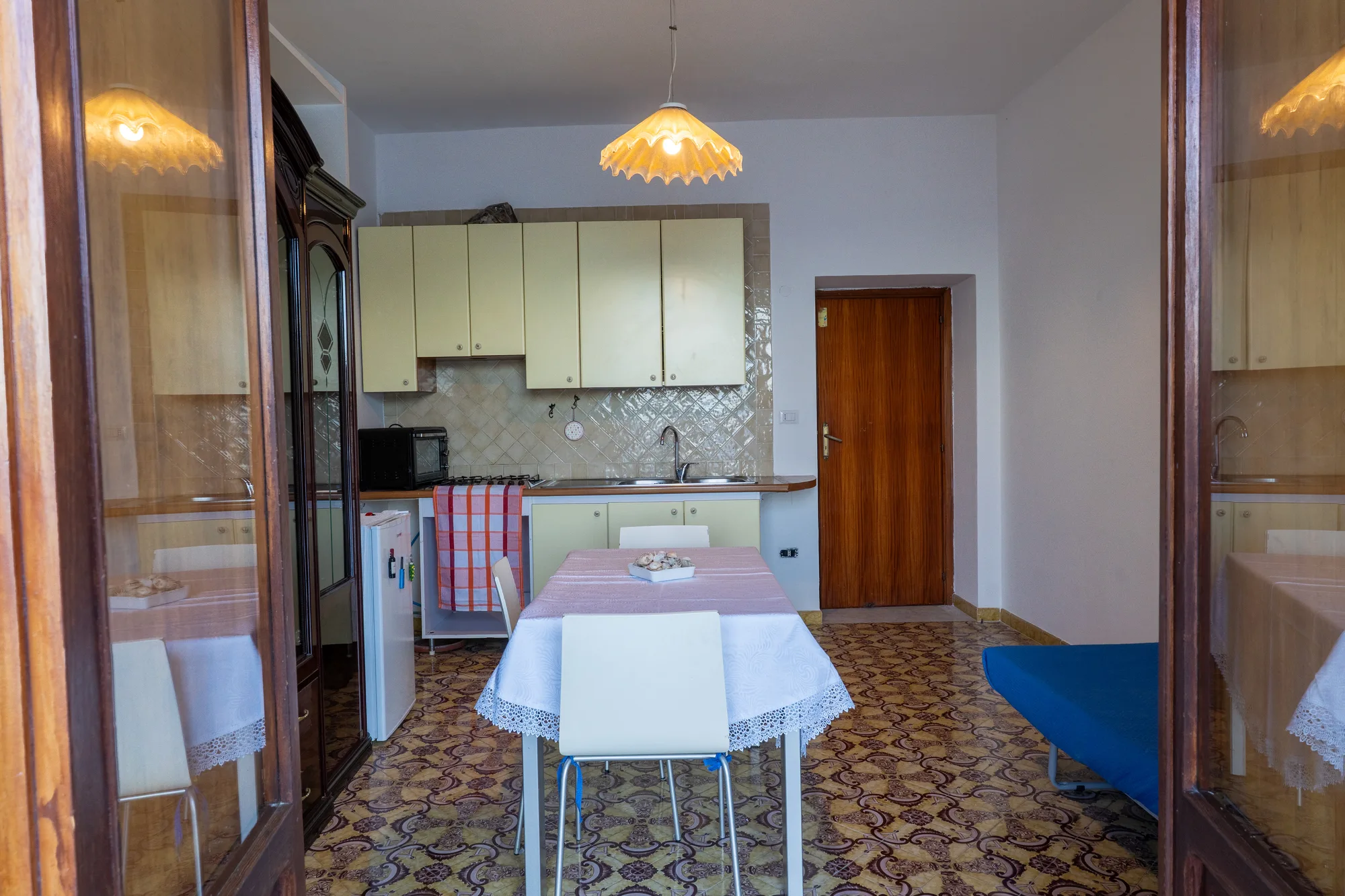Kitchen and dining area photographed through open balcony doors - interior photography on the Amalfi Coast by Cinereo