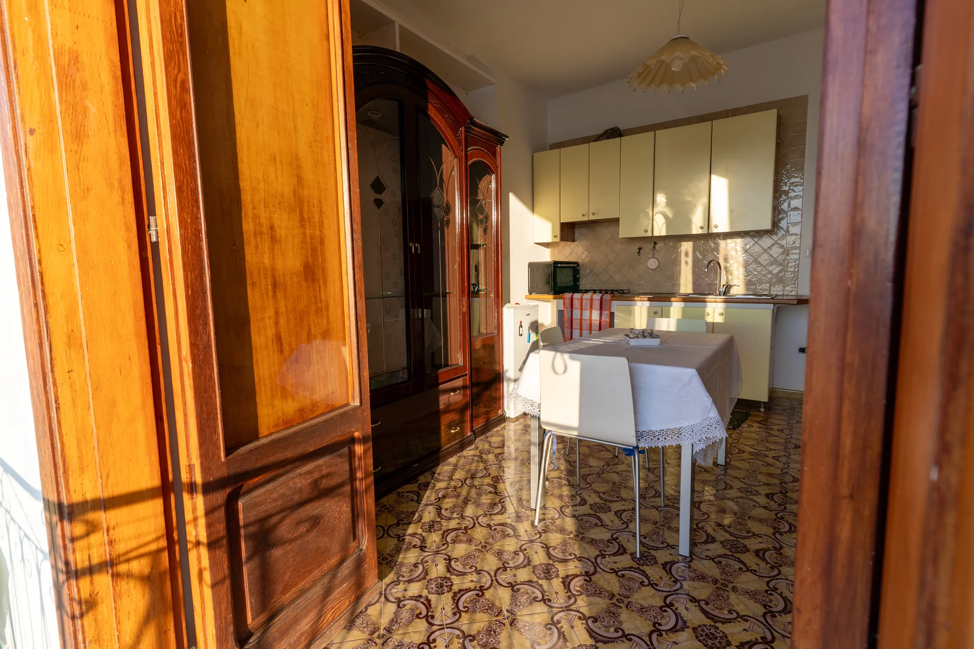 Interior dining area with golden morning light and open door - interior photography on the Amalfi Coast by Cinereo