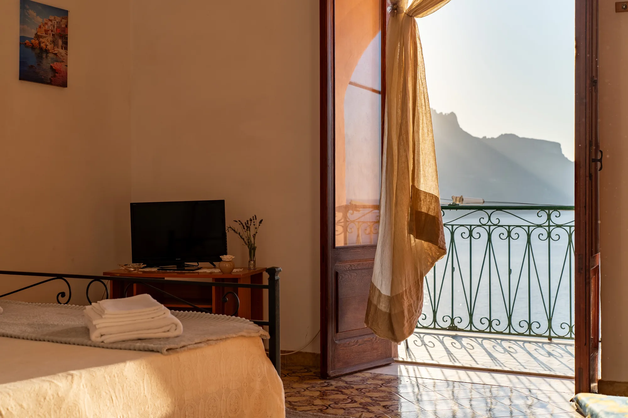 Bedroom and balcony composition with direct sea view - interior photography on the Amalfi Coast by Cinereo