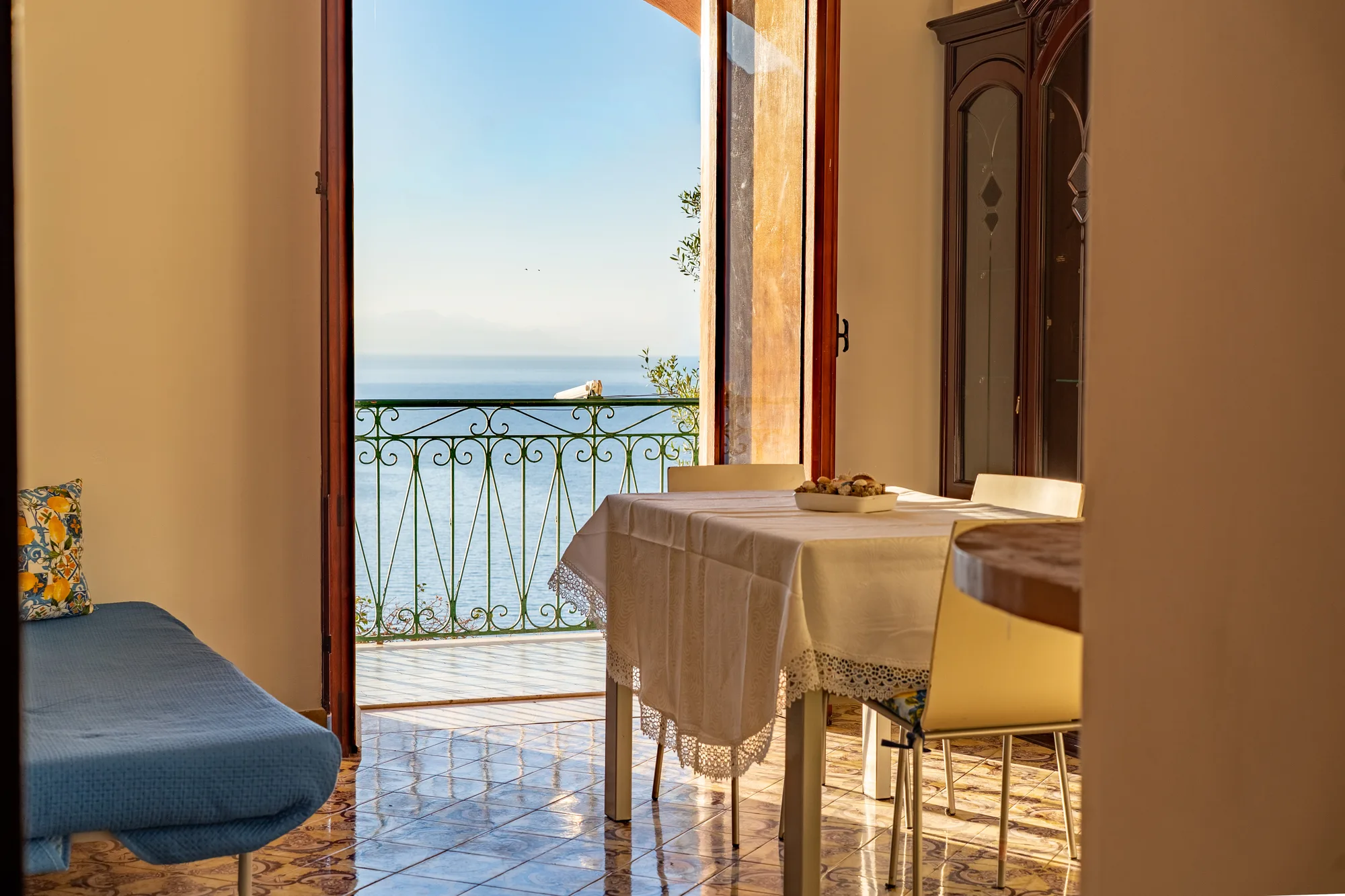 Dining corner and balcony doorway with Amalfi Coast light - interior photography on the Amalfi Coast by Cinereo