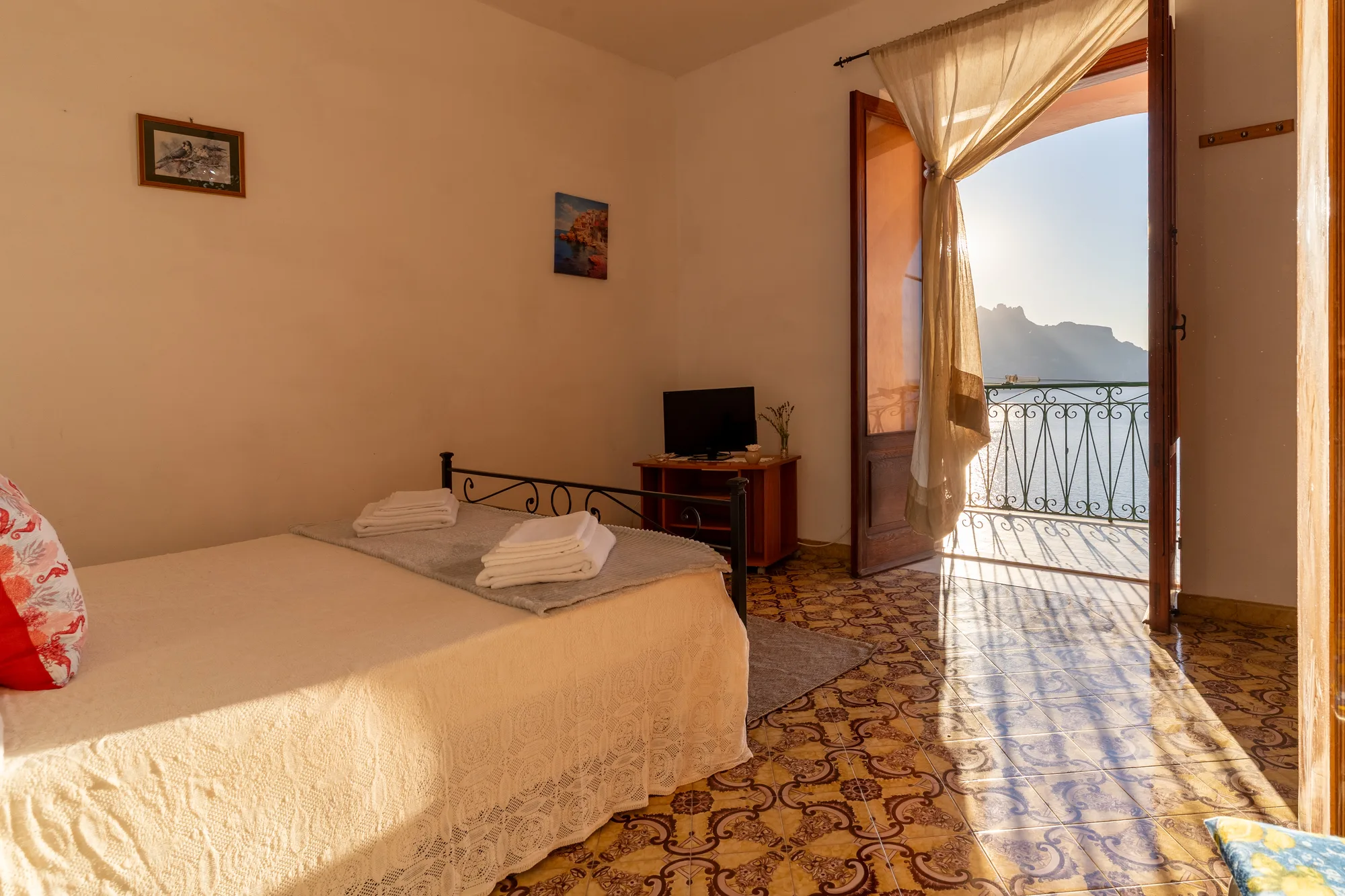 Sea-facing bedroom composition in the first morning light - interior photography on the Amalfi Coast by Cinereo