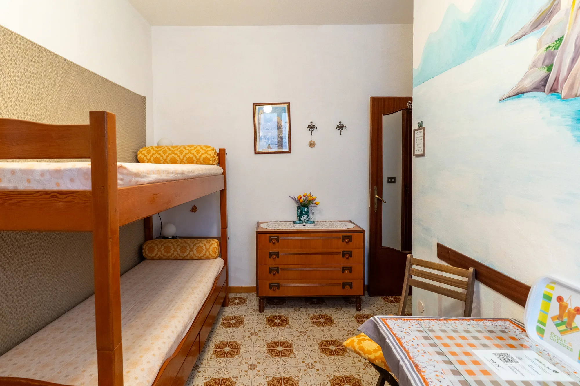 Bunkbed room with mural wall and tidy guest setup - interior photography on the Amalfi Coast by Cinereo