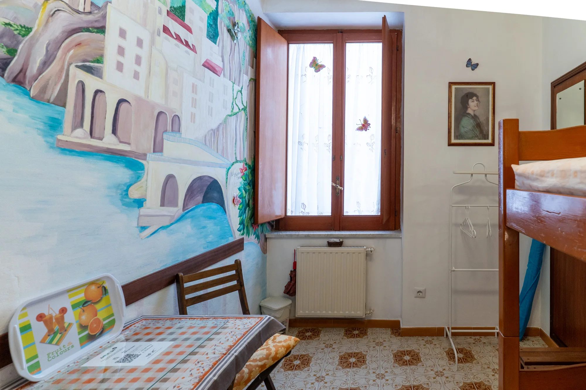 Window-side angle showing the bunkbed, mural and seating area - interior photography on the Amalfi Coast by Cinereo