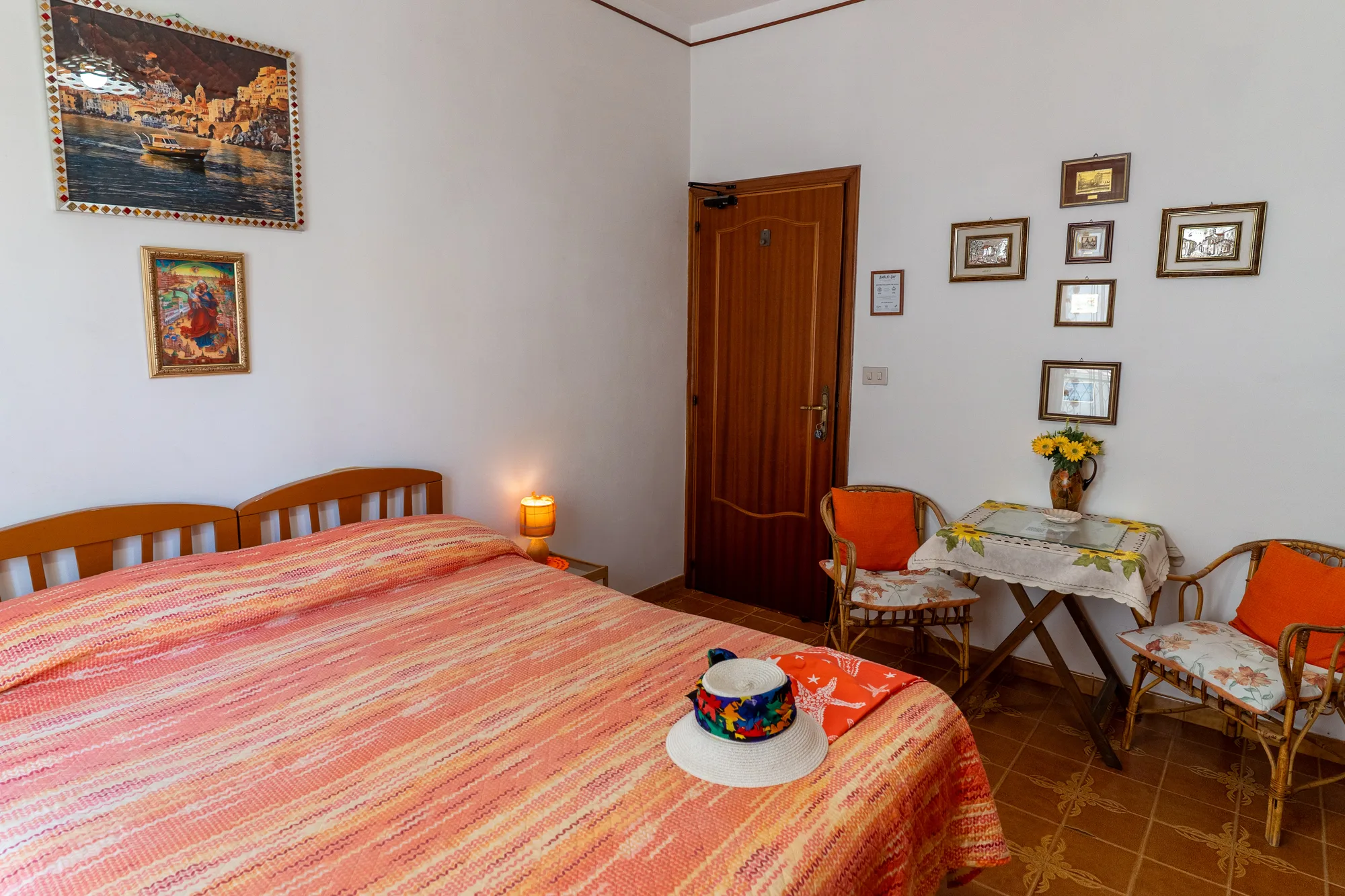 Bed, table and framed wall details composed for a hospitality listing - interior photography on the Amalfi Coast by Cinereo