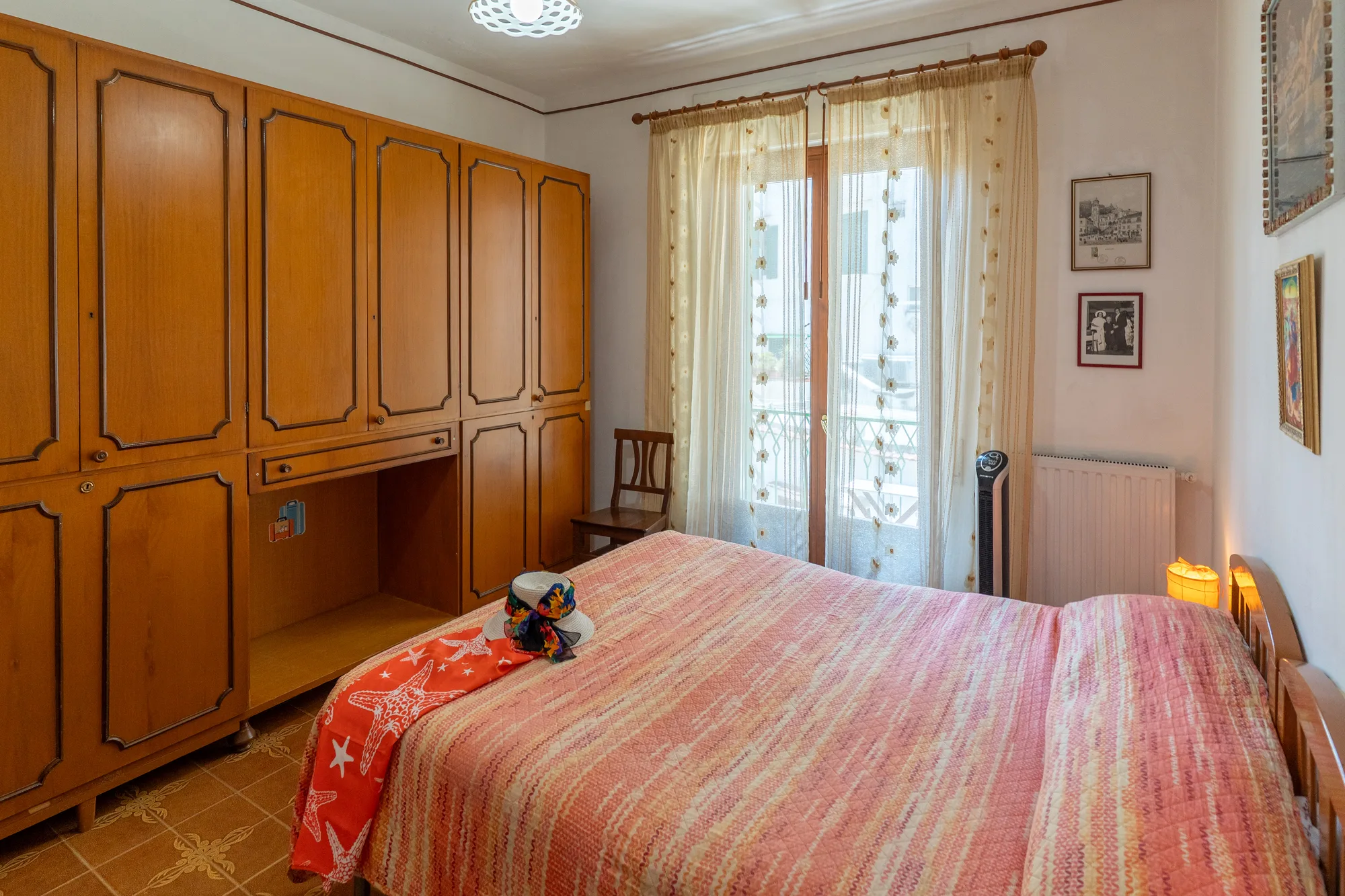 Bedroom with wardrobe wall and soft lace curtains - interior photography on the Amalfi Coast by Cinereo