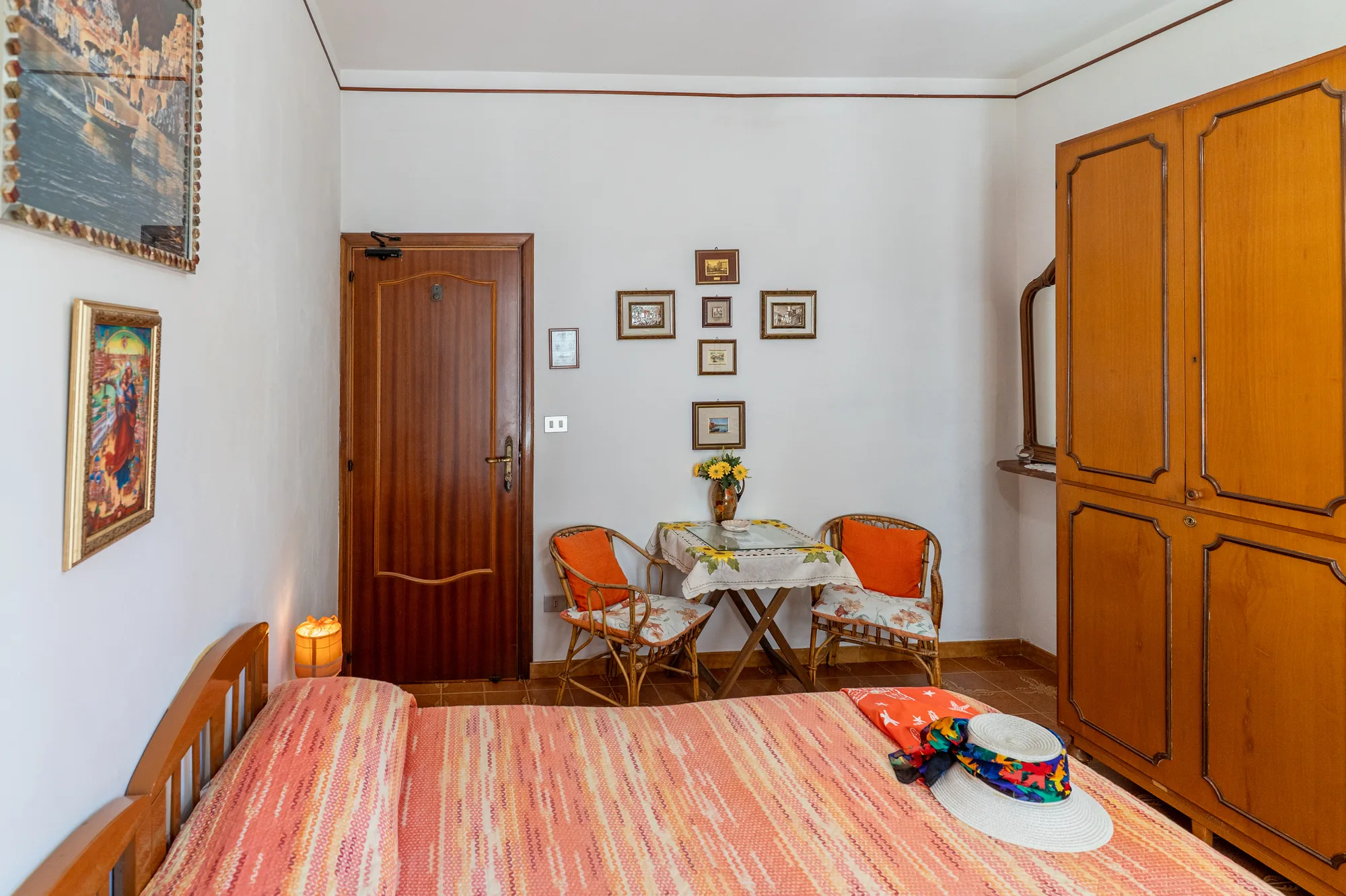 Wide bedroom angle showing bed, wardrobe and table together - interior photography on the Amalfi Coast by Cinereo