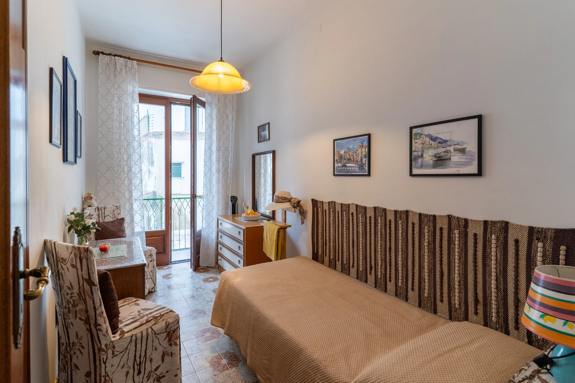 Single bedroom photographed from the entrance to show the full layout - interior photography on the Amalfi Coast by Cinereo