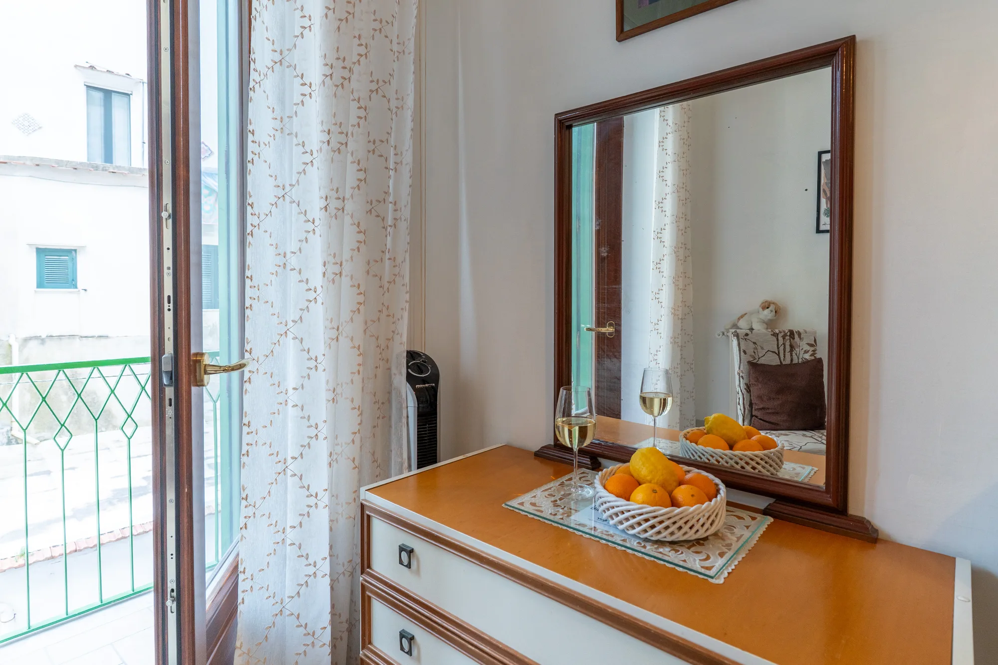 Balcony and dresser detail with daylight entering the room - interior photography on the Amalfi Coast by Cinereo