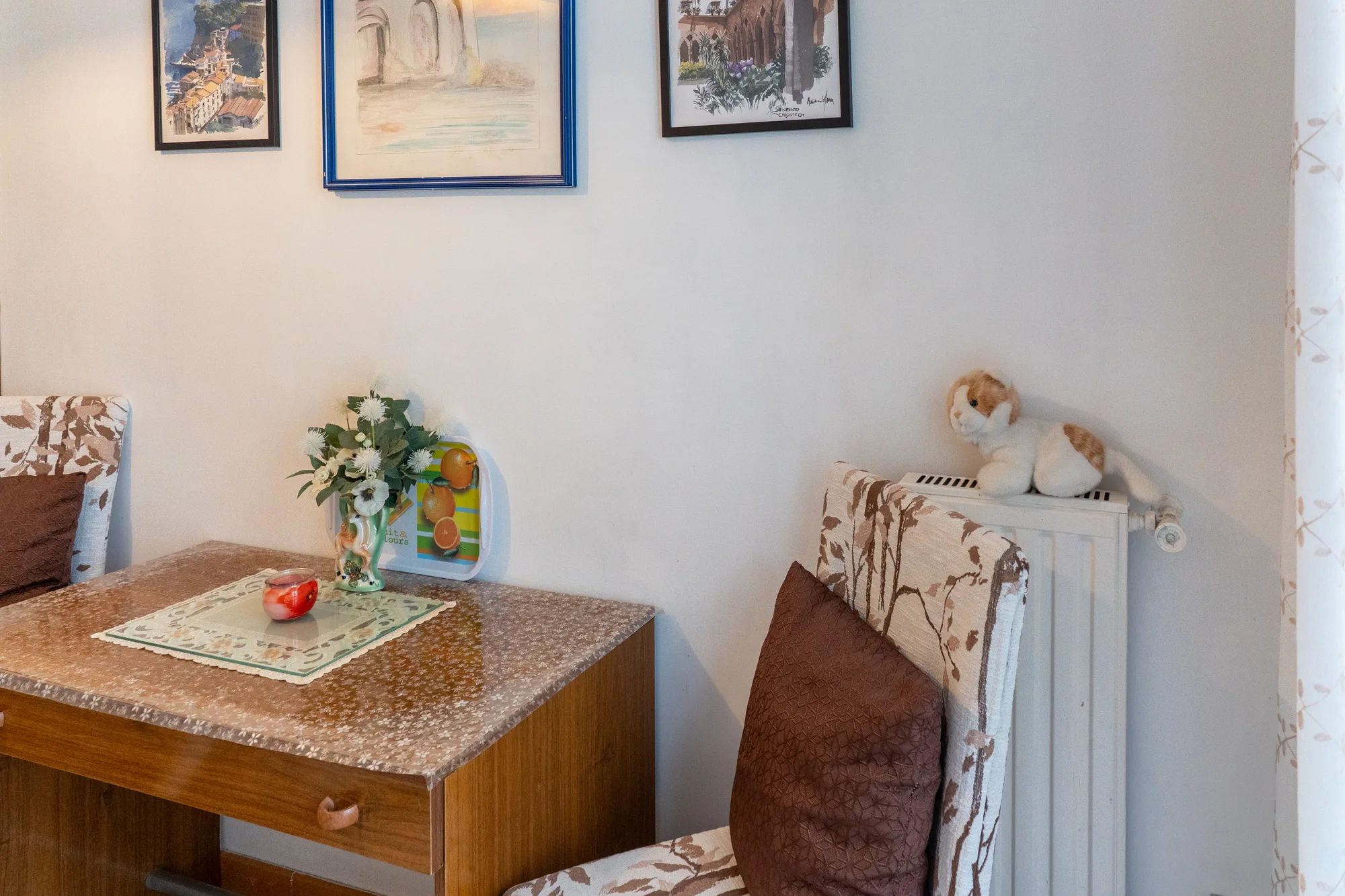 Small table and framed wall art in a compact guest room - interior photography on the Amalfi Coast by Cinereo